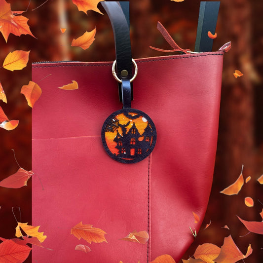 handpainted haunted house with bats and moon on a vegetable tan leather with lobster clasp