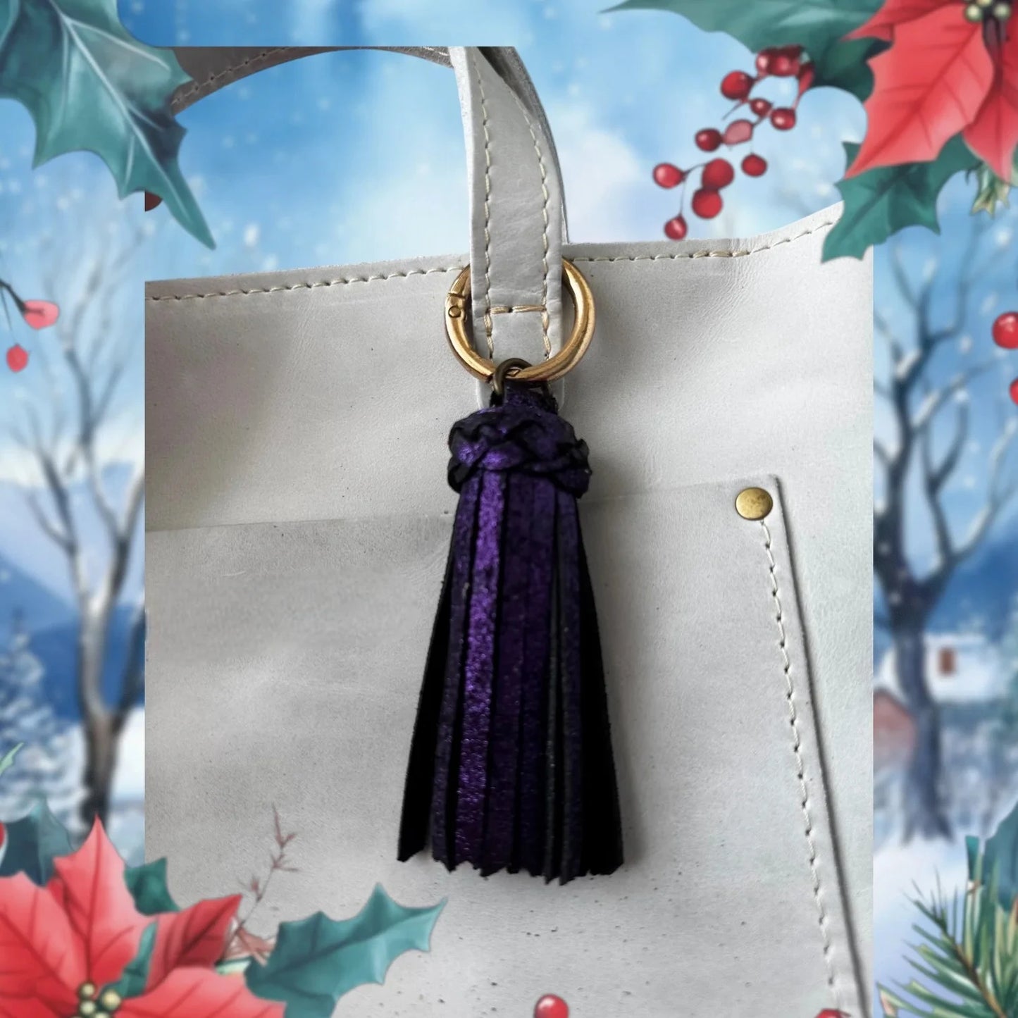 White handbag with a purple tassel keychain against a festive background with holly leaves and berries.