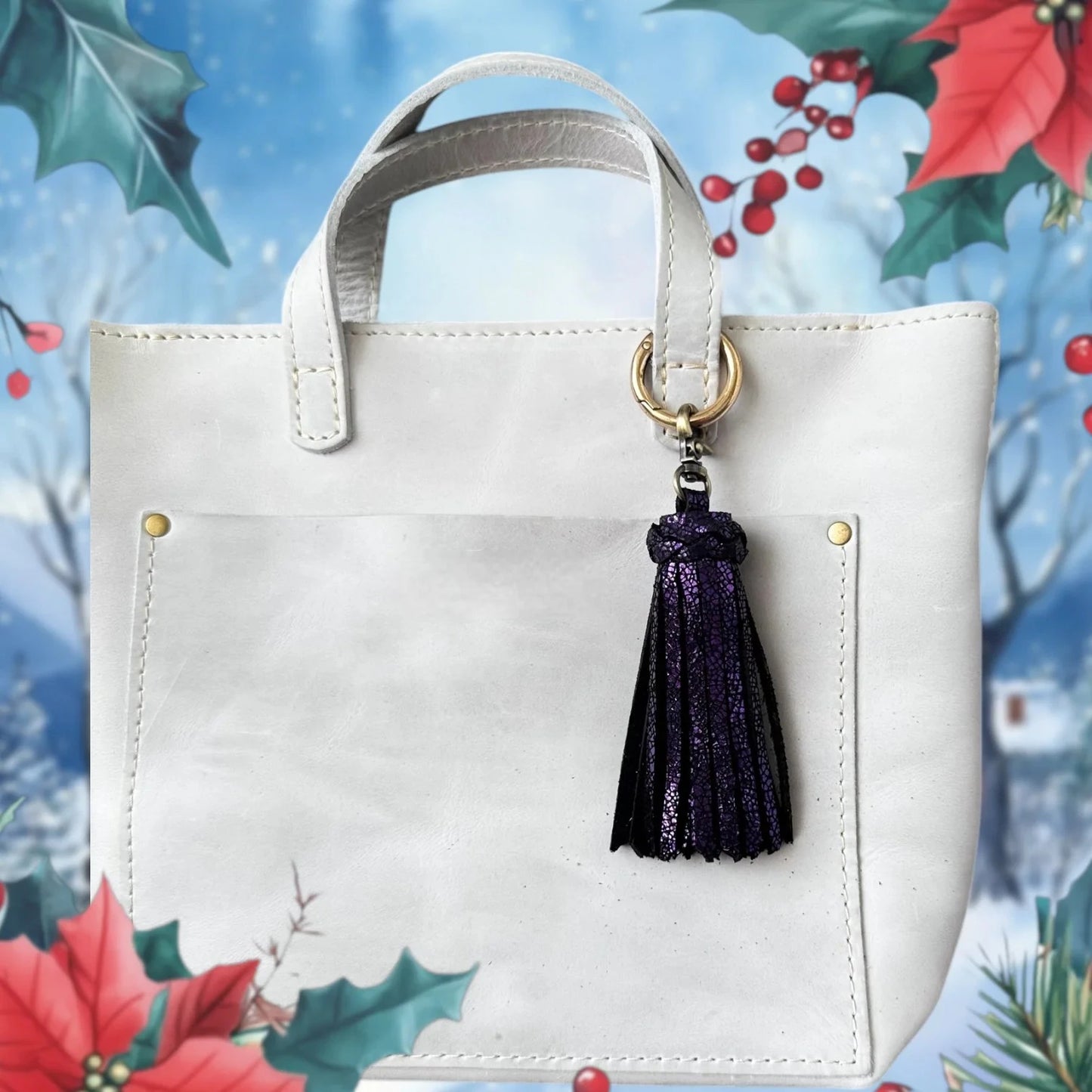 White handbag with a purple tassel on a decorative background with holly and berries.