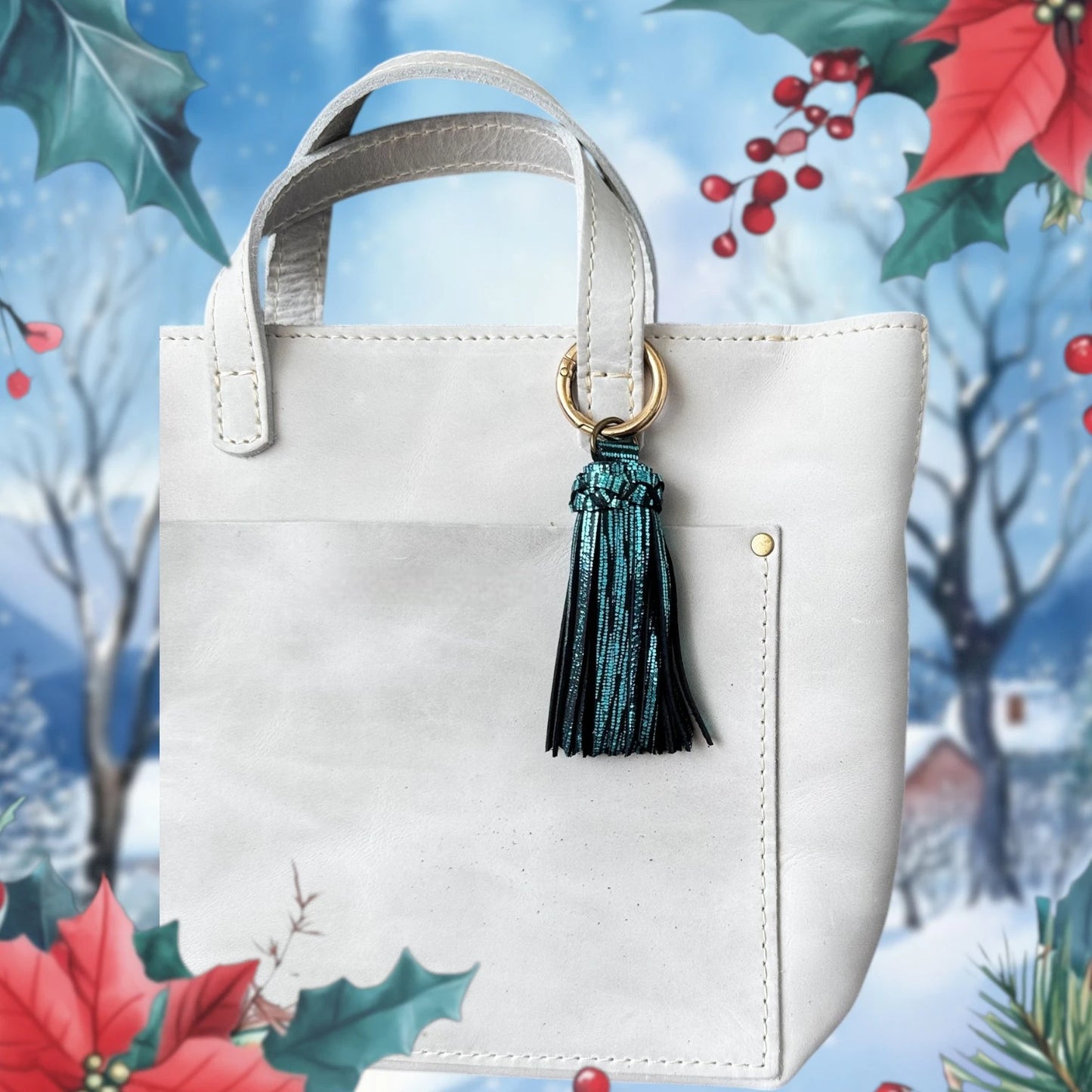 White handbag with a green tassel against a festive background with holly and poinsettia.