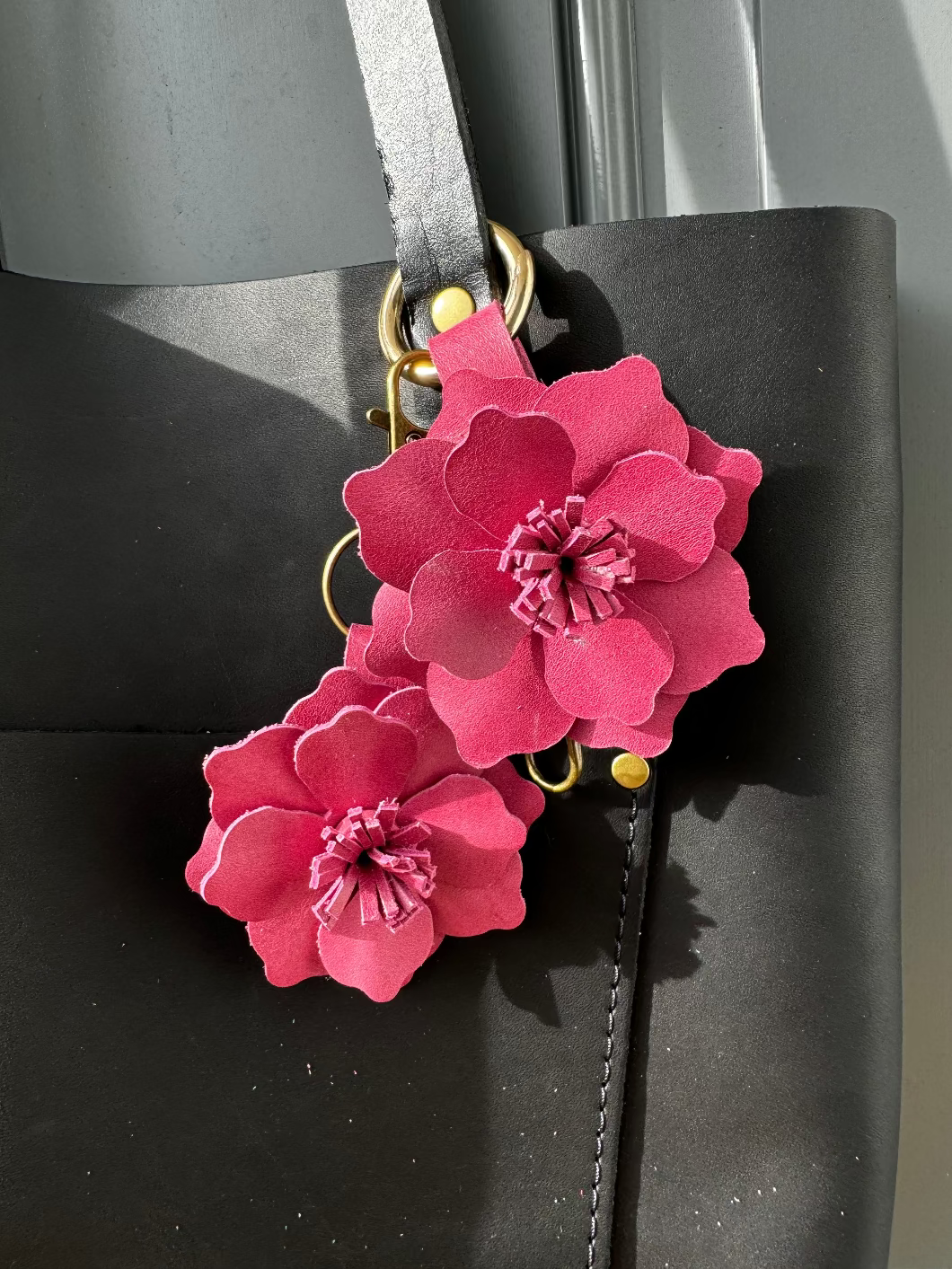 Everbloom Leather Flower Large - Old Rose on a black bag