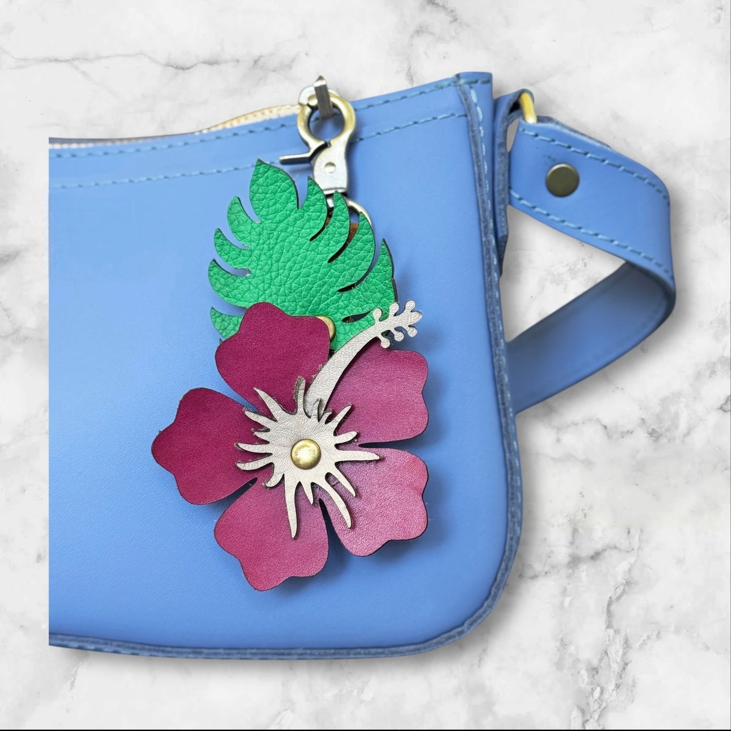 Pink with blush stamen hibiscus flower on a blue bag
