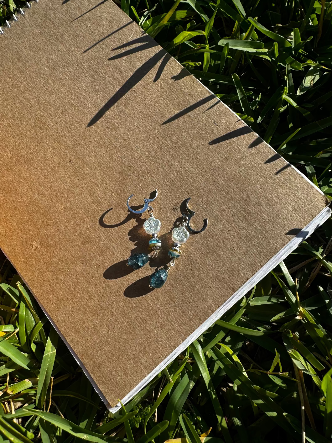 Pair of earrings on a old book