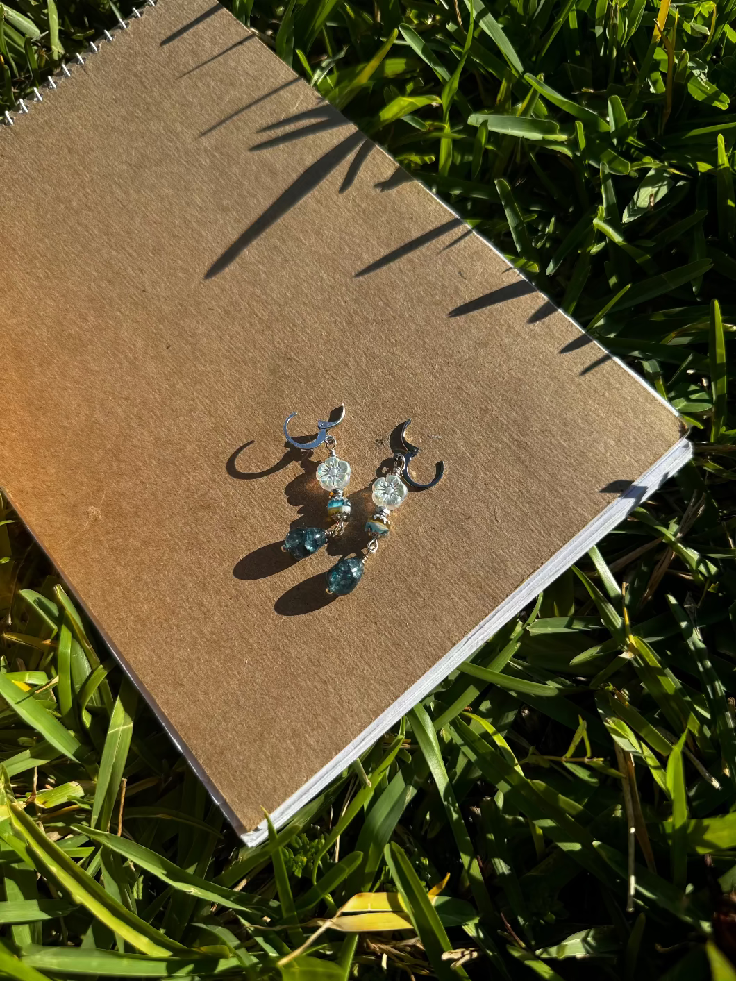 Pair of earrings on a old book