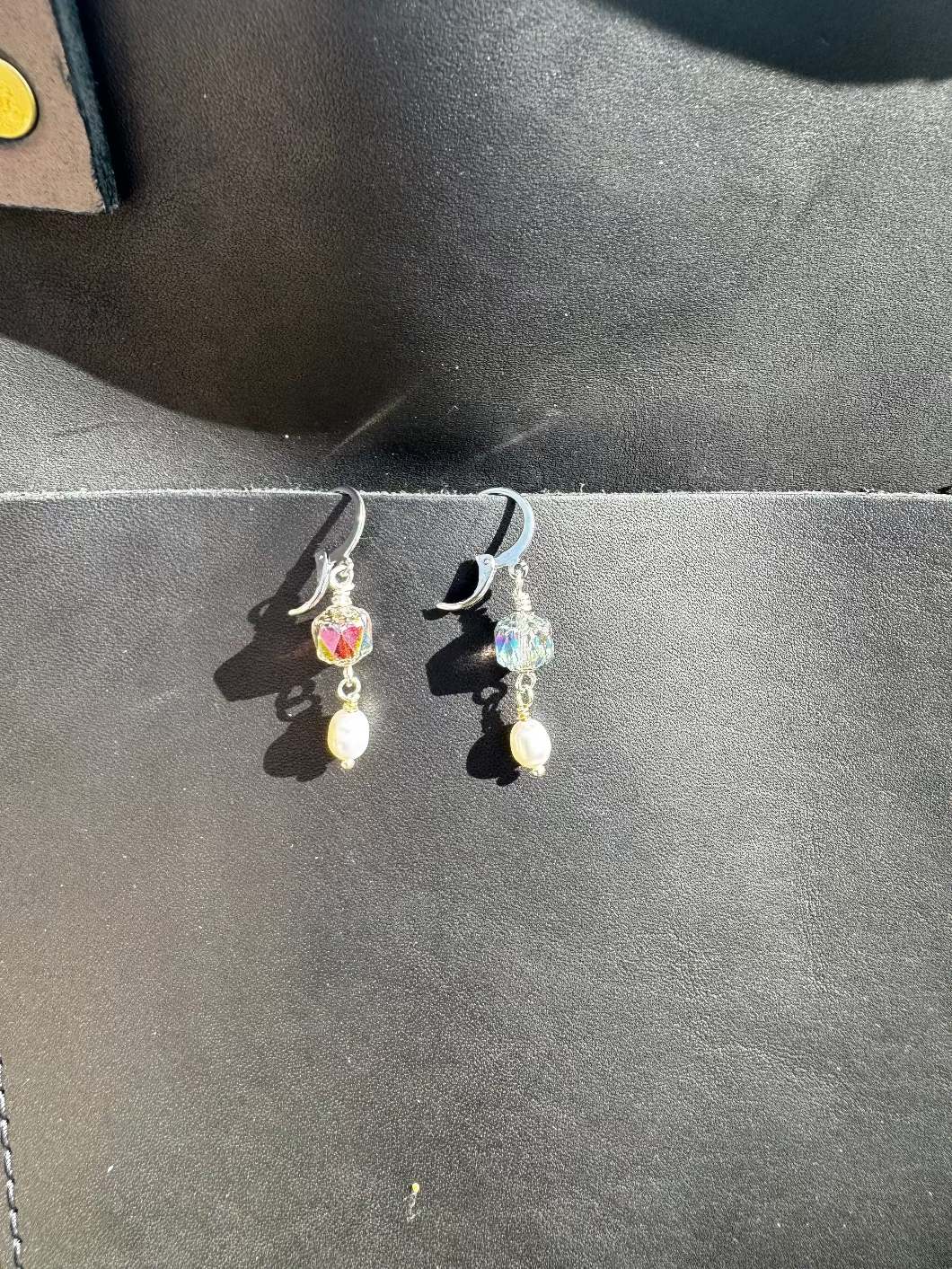 Pair of earrings on a black bag