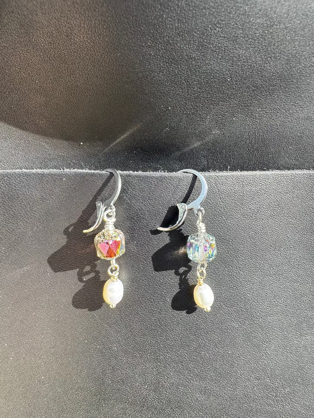Pair of earrings on a black bag