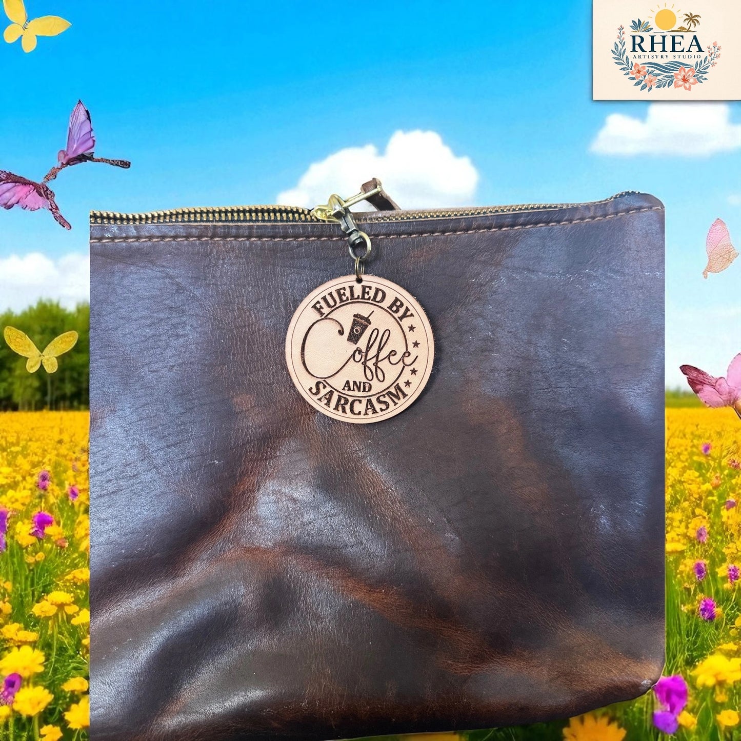 Brown leather pouch with a wooden tag reading 'Fueled by Coffee and Sarcasm' against a colorful background with flowers and butterflies.