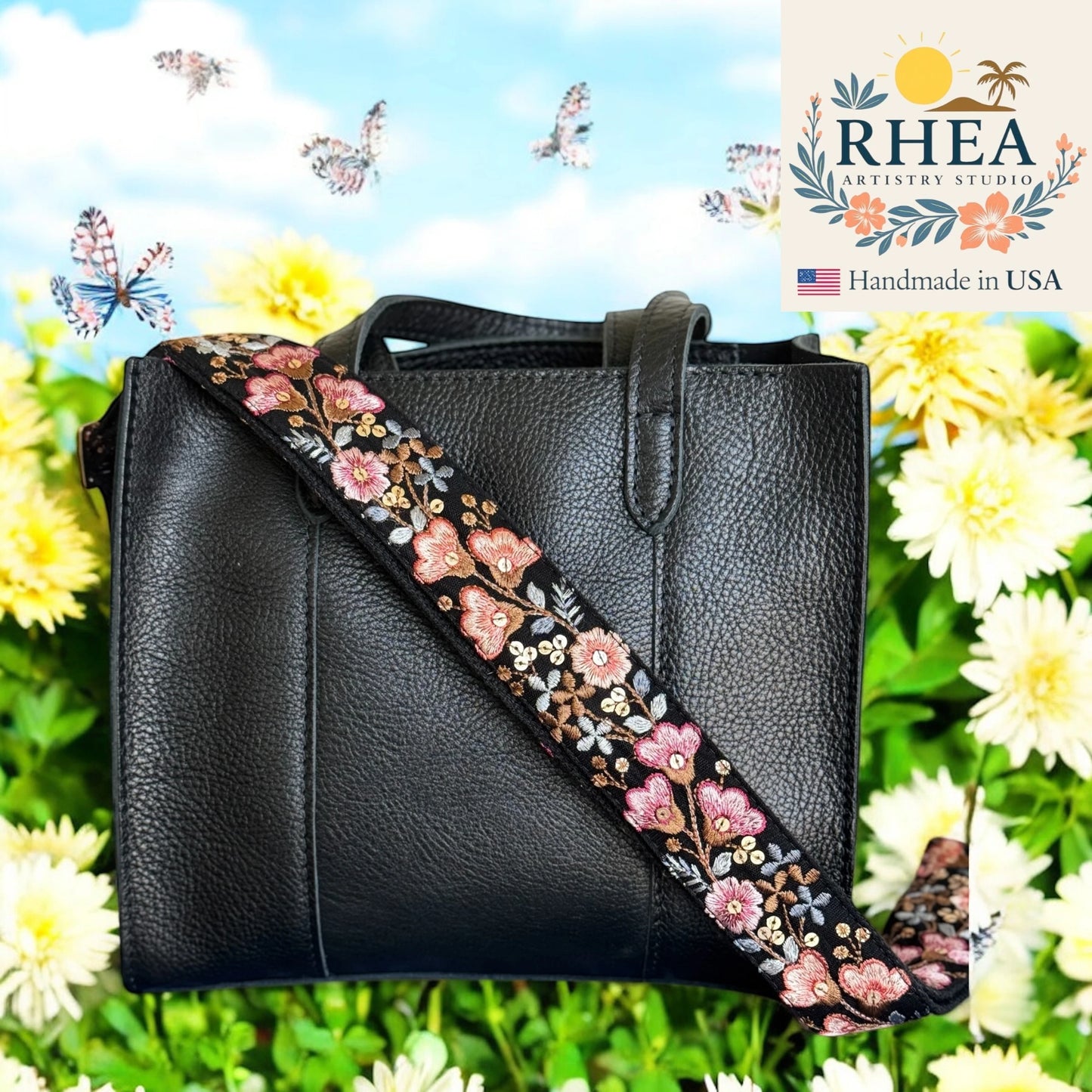 Black handbag with a floral purse strap against a colorful background with flowers and butterflies, featuring the RHEA Artisan Studio logo.