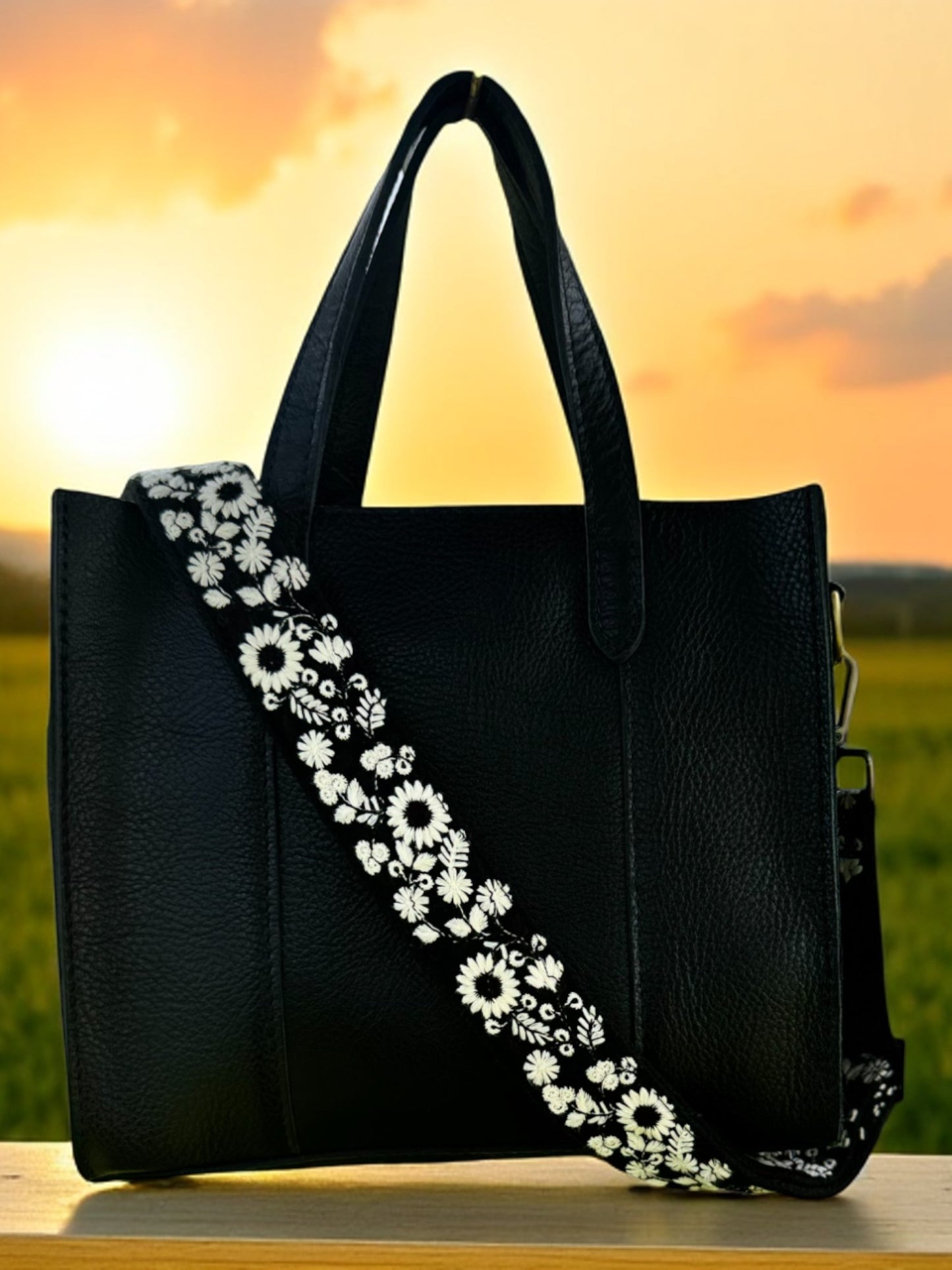 Elegant black fabric crossbody strap with detailed white wildflower embroidery, perfect for handbags and DSLR cameras. Ethically handcrafted with a modern flair.