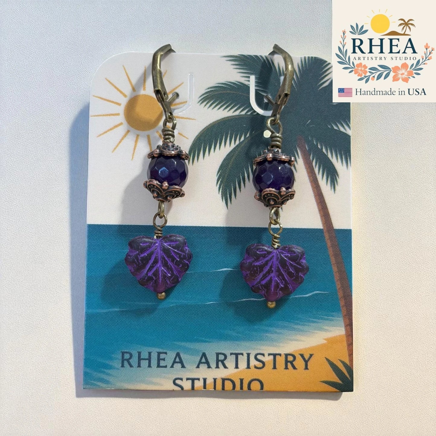 Purple glass bead earrings with Czech leaf accents and antique brass French hooks.