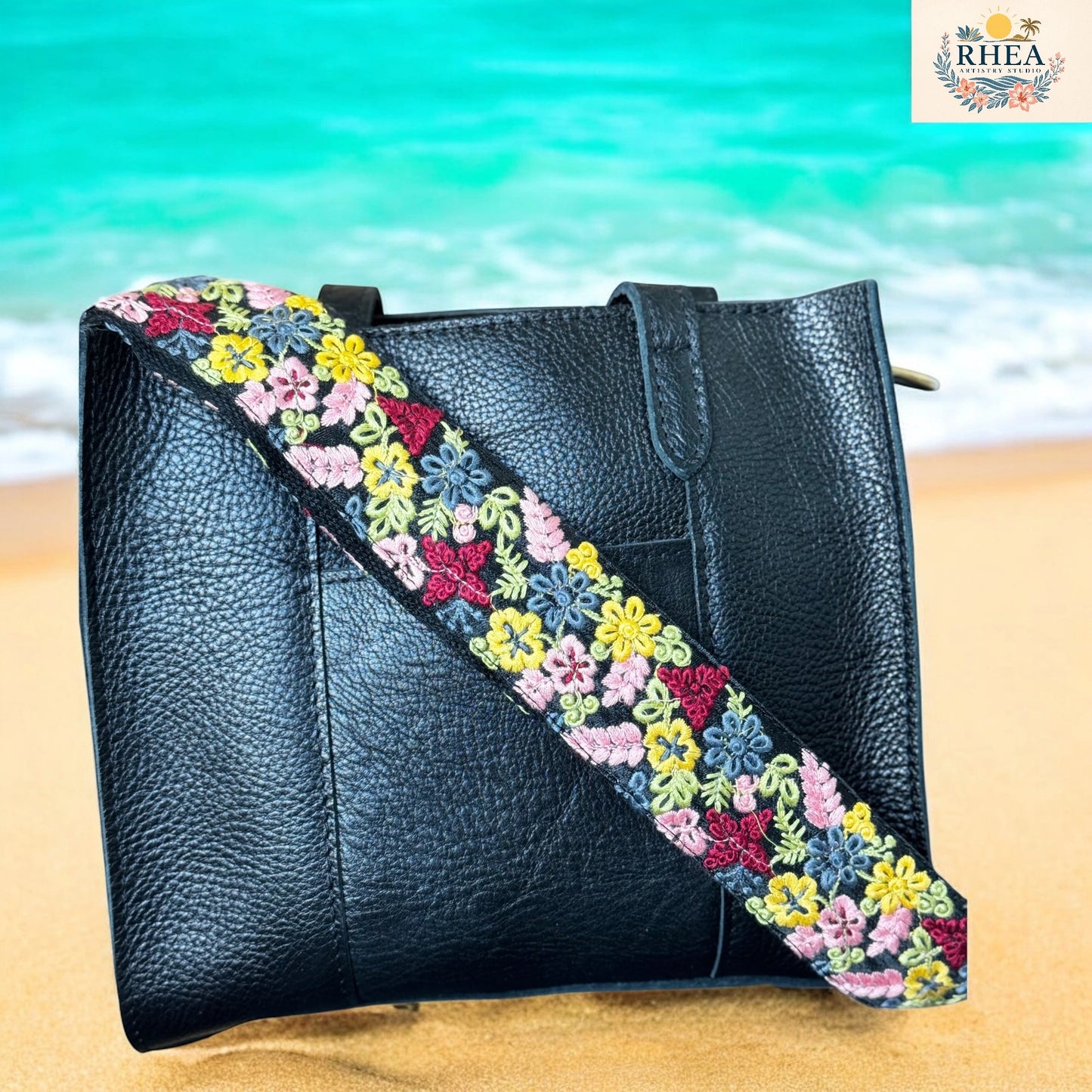 Floral bag strap featuring a spring-inspired palette of yellow, pink, and sky blue blooms on black