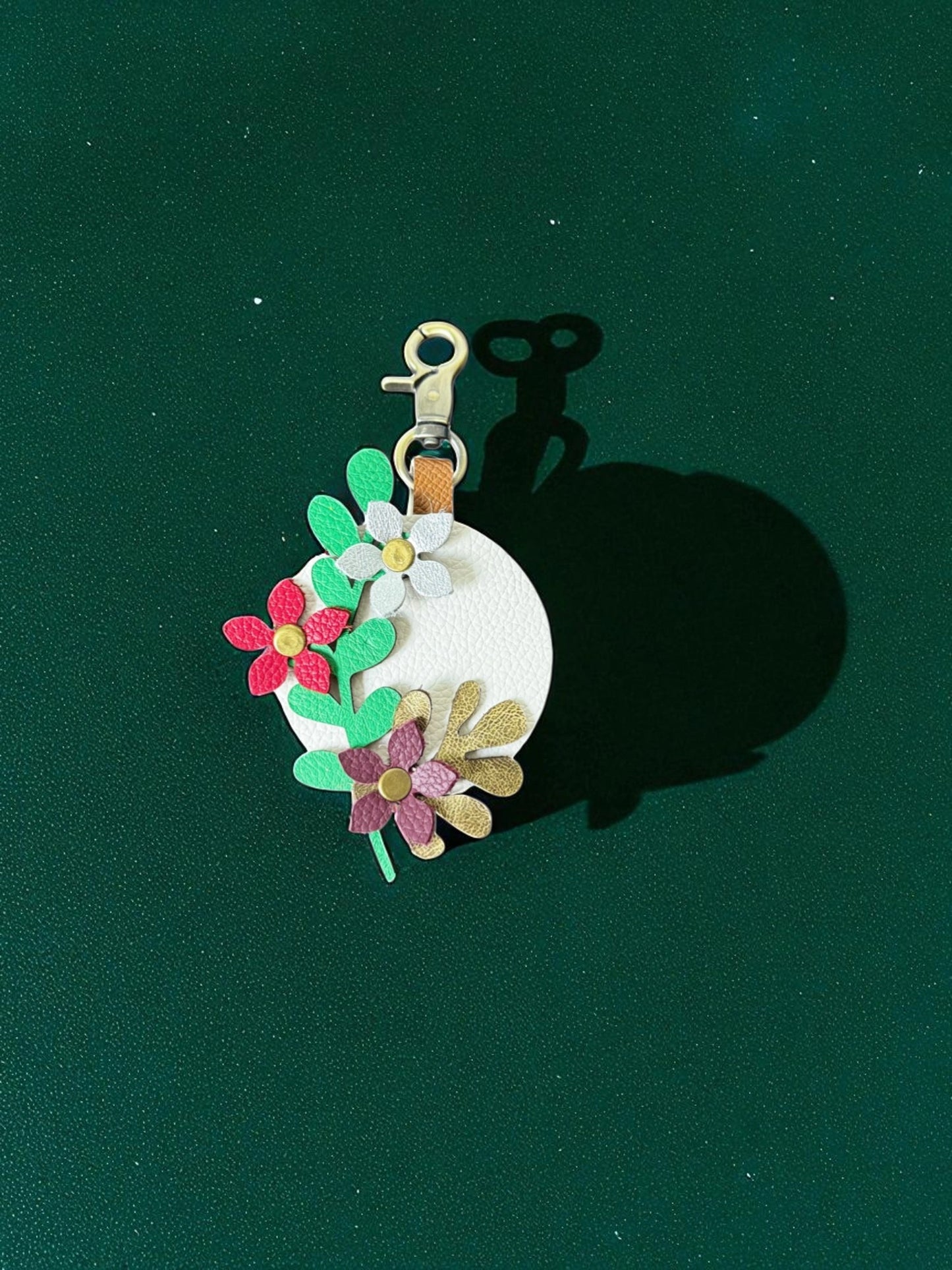 Floral keychain on a green background