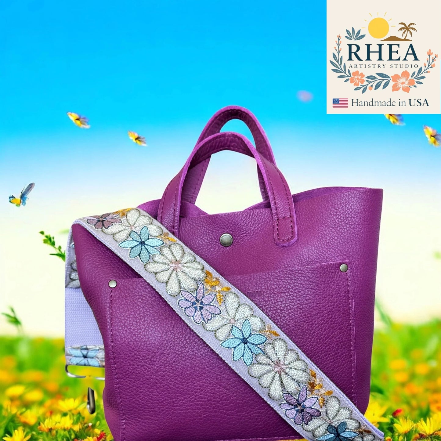 Purple handbag with a floral strap against a colorful background, featuring the RHEA Artistry Studio logo.
