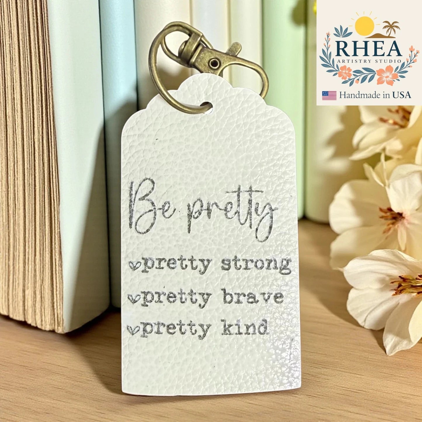 Handcrafted Engraved Leather Tags – Empower Collection featuring inspirational words on premium leather, artisan-made bag and keychain charms.