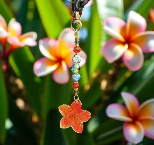 Flower-shaped keychain with beads against a floral background