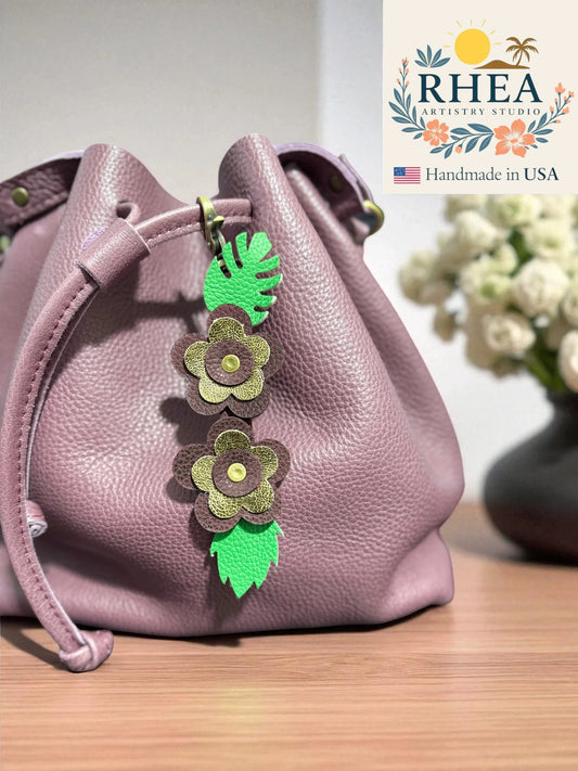 Flora Luxe handmade leather flower charm in gold and burgundy speckles, elegant floral purse charm and keychain