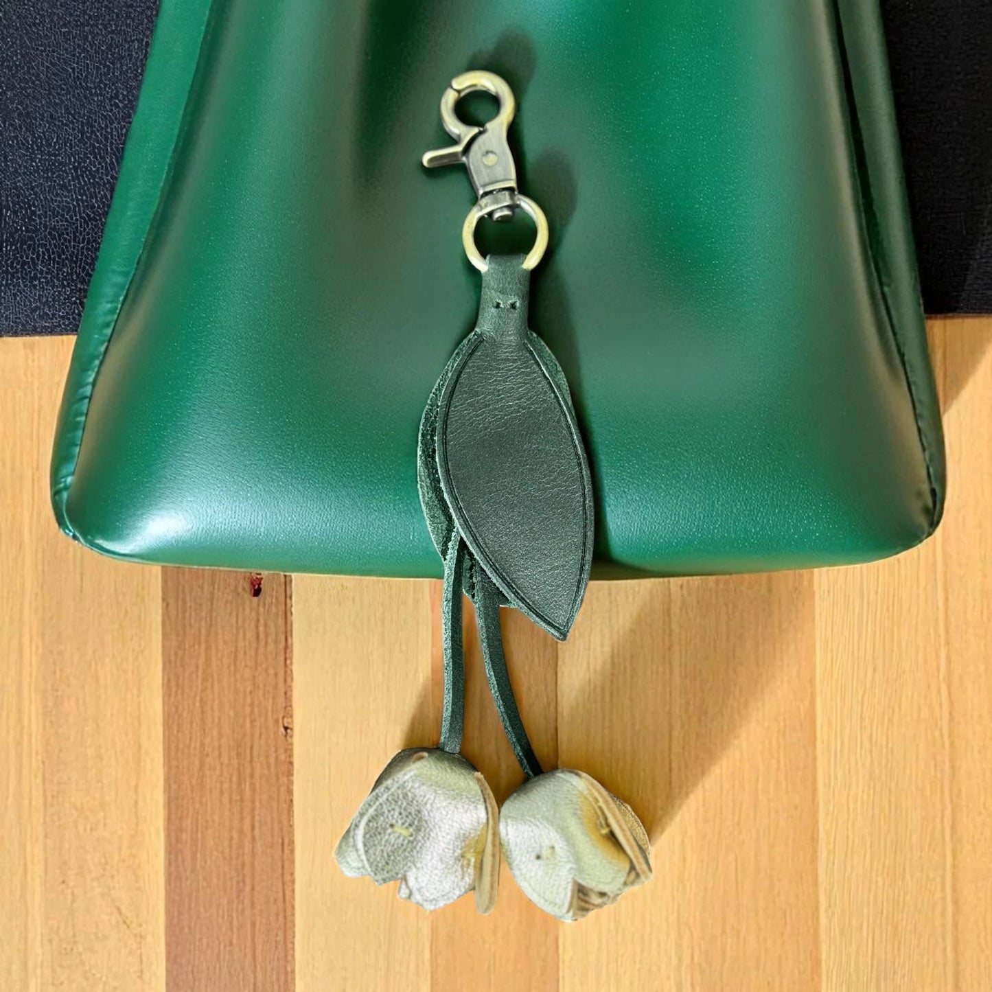 gold green tulip leather flower on a green hand bag