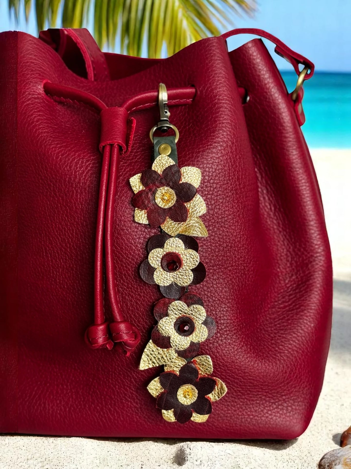 LeatherCharm clipped to a handbag handle with strong brass hardware