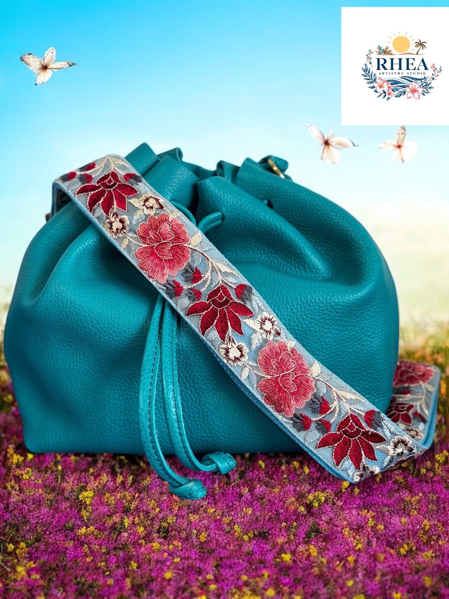 Fabric Strap with light blue color tulle and red rose flowers in full bloom on a bag