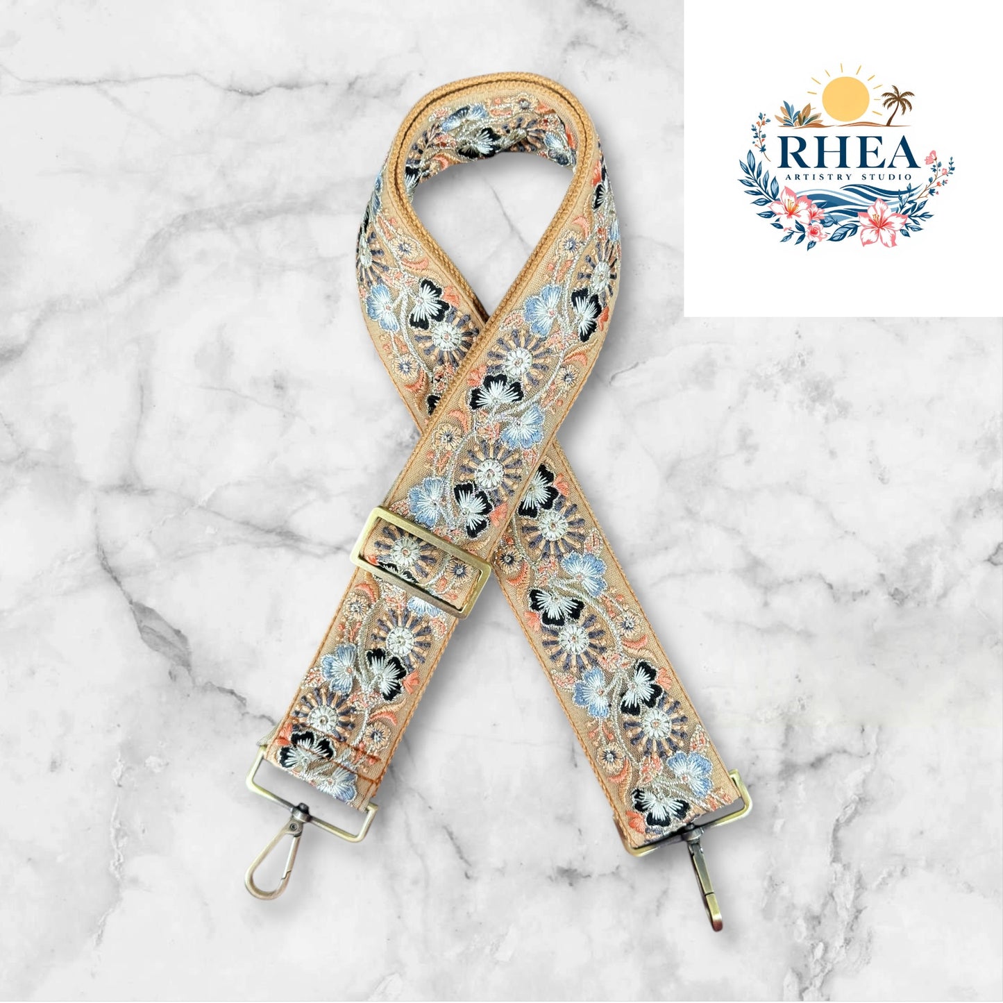 A light orange floral embroidered strap placed on a marble surface