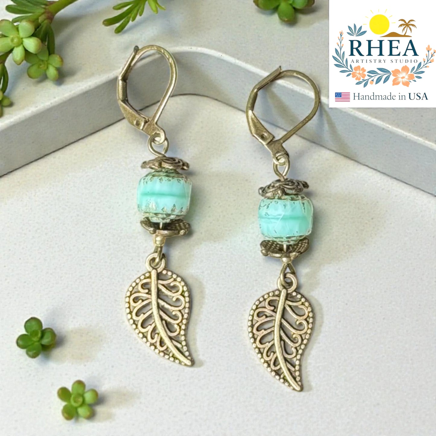 Handcrafted drop earrings with antique brass leaf and glass bead