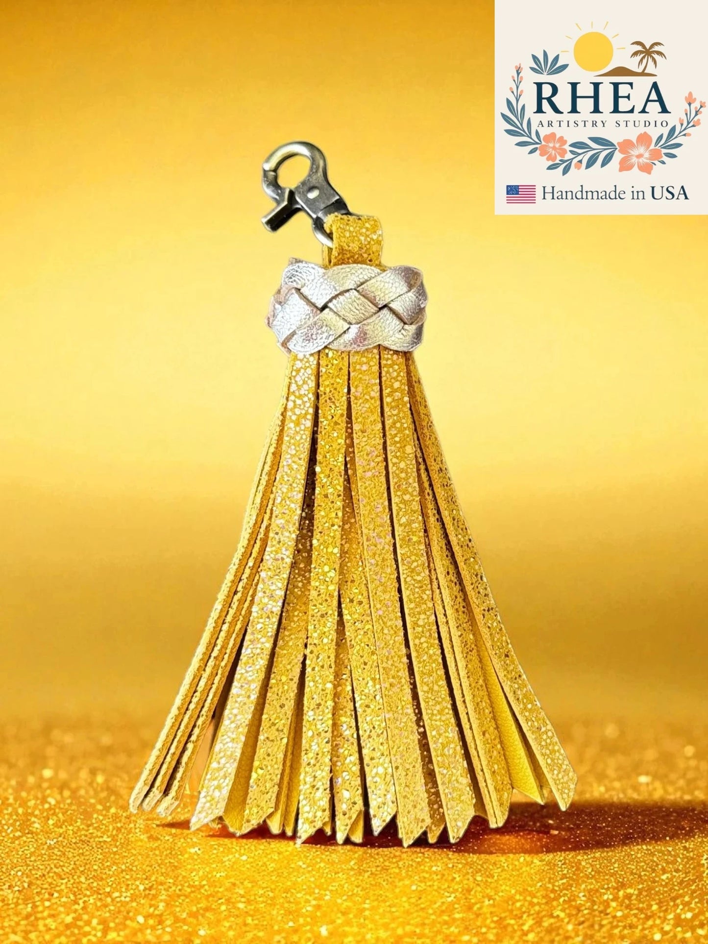 lemon zest tassel keychain with braided design on a yellow background, featuring the RHEA brand.