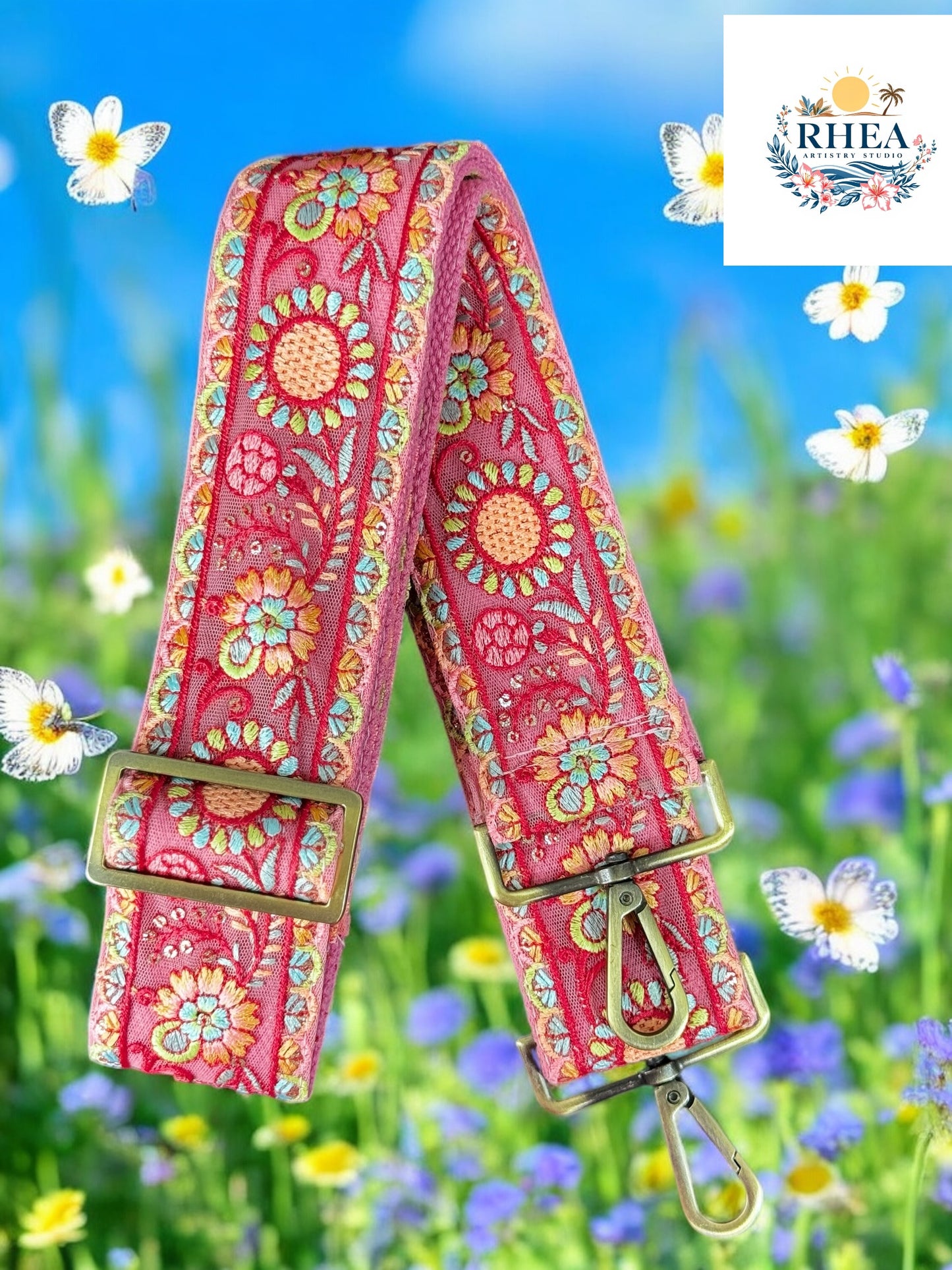 Handcrafted purse strap in soft pink with embroidered zinnias and teal accents,
