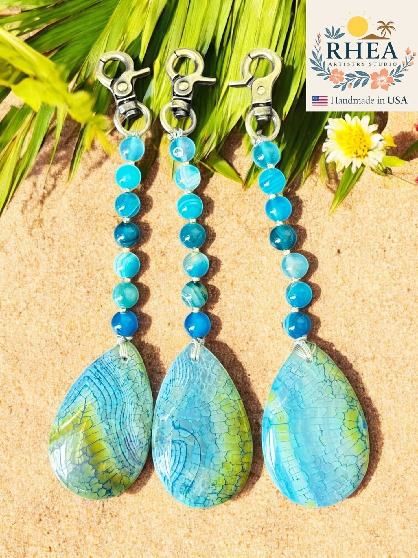 Rhea Artistry Studio blue agate gemstone charm with teardrop pendant and lobster clasp, inspired by coastal waters.