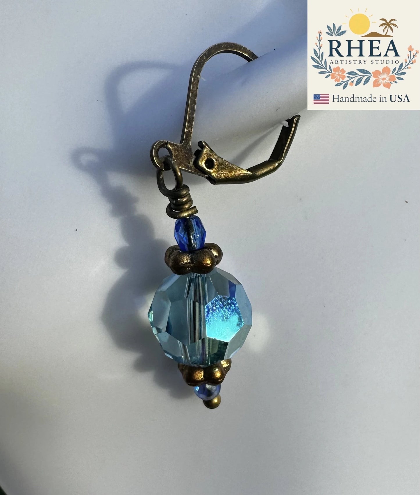 Rhea Artistry Studio light blue Czech glass bead earrings with brass hardware and crystal accents, 1.5-2 inches long.
