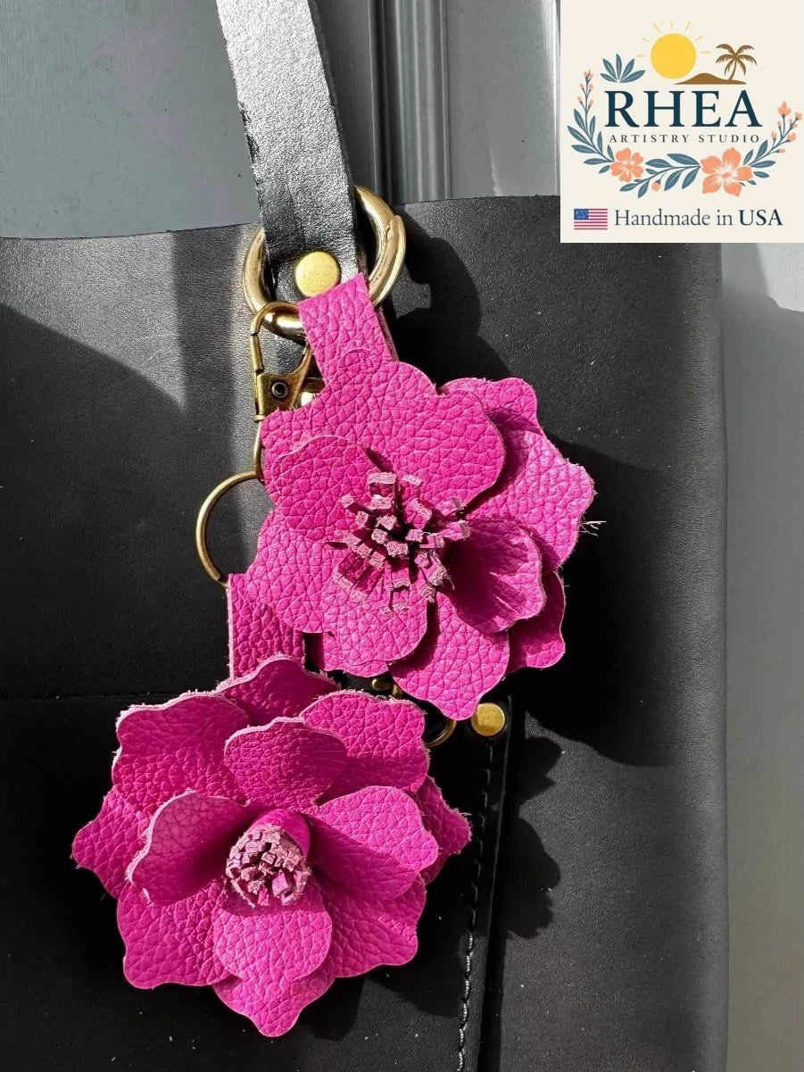 Rhea Artistry Studio large pink leather flower bag charm with layered petals and a hand-cut stamen, featuring a lobster clasp and split ring.