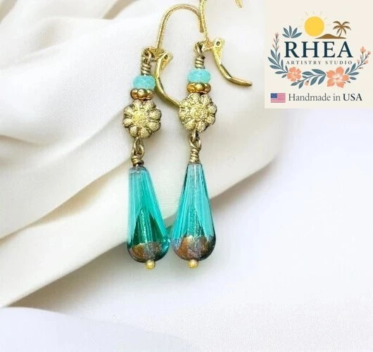 Rhea Artistry Studio long turquoise and gold glass drop earrings with dahlia accent and brass hardware.