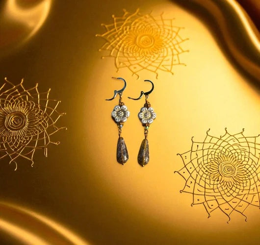 Pair of earrings with decorative elements on a gold background