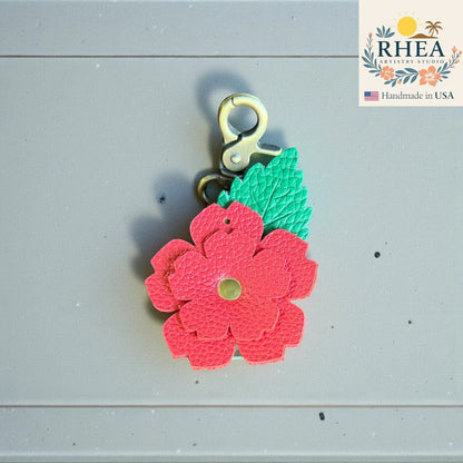 Leather rose charm shown with detailed leaf engraving