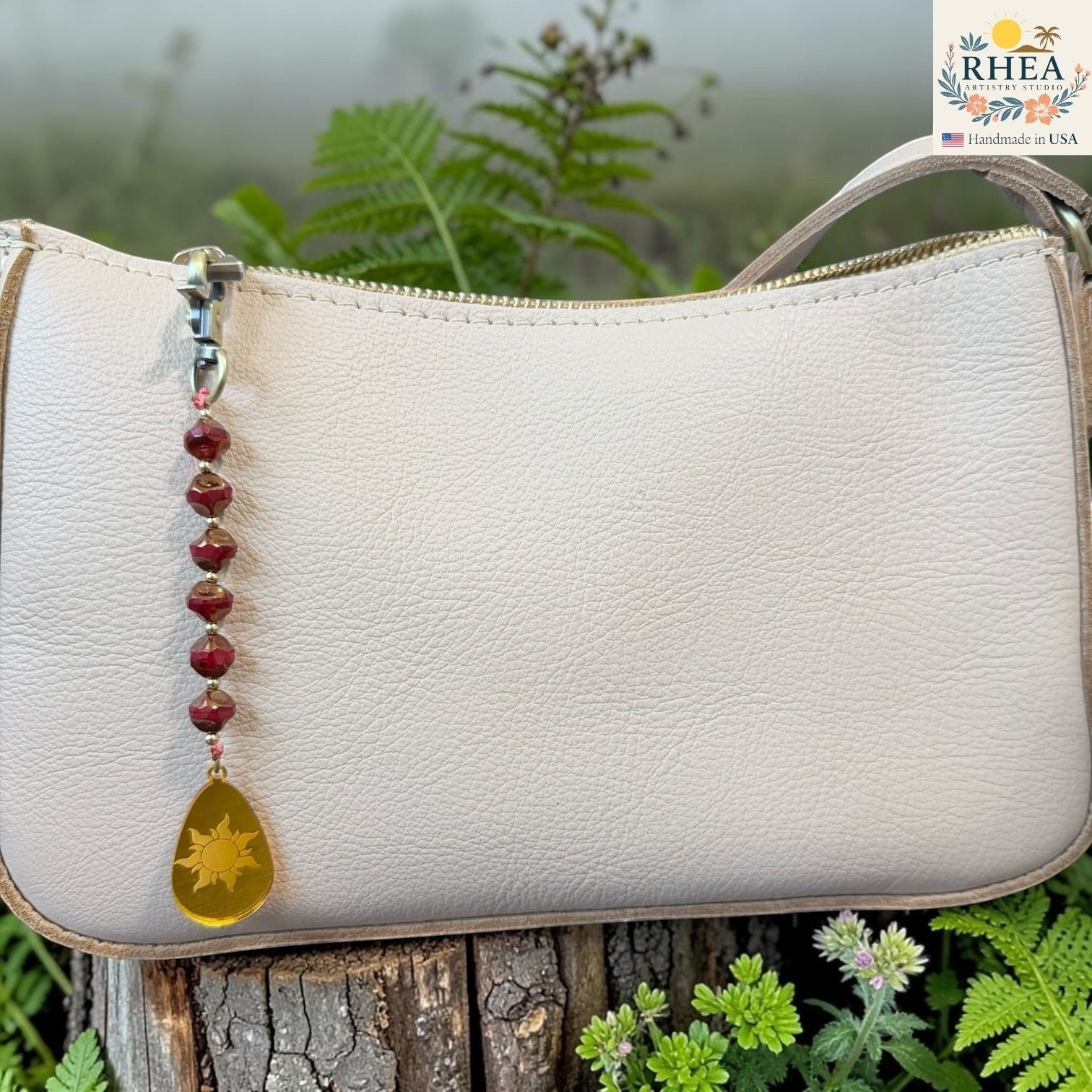 White handbag with decorative bead chain against a natural background