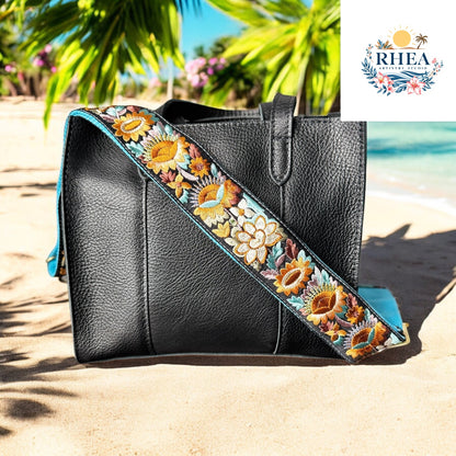 Ethically crafted embroidered replacement purse strap in aqua blue, featuring intricate sunflower motifs on a black background.