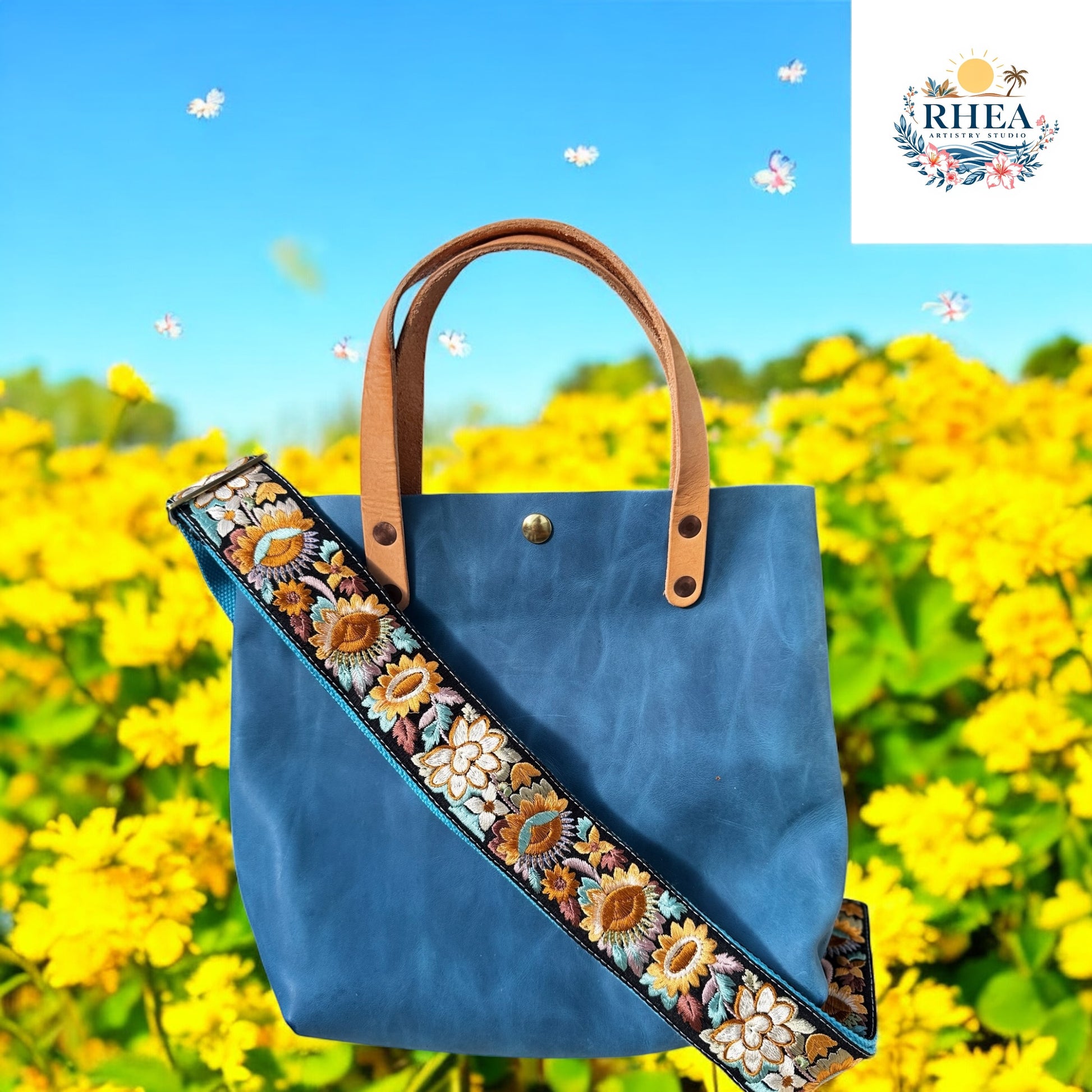 Ethically crafted embroidered replacement purse strap in aqua blue, featuring intricate sunflower motifs on a black background.

