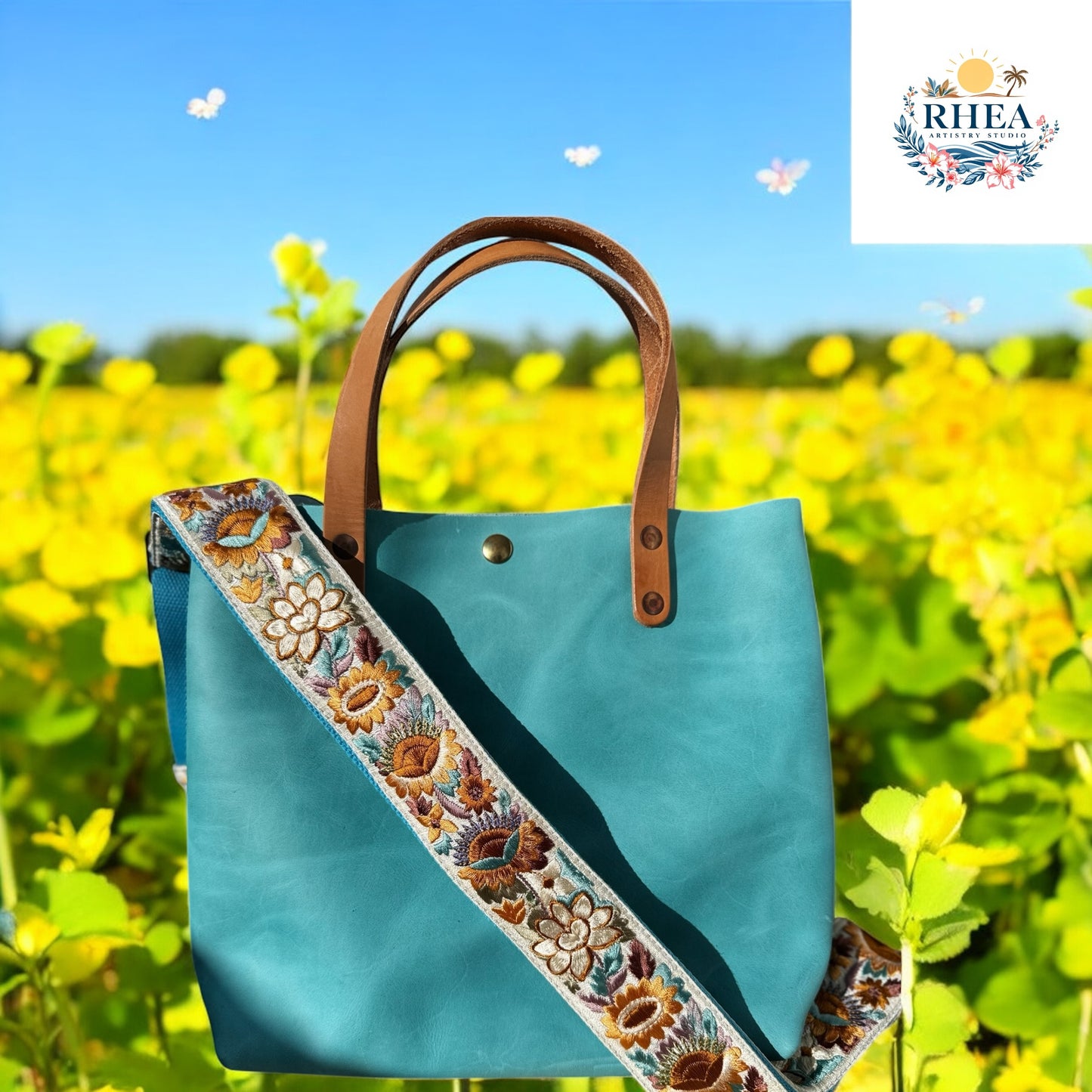 Ethically crafted embroidered replacement purse strap in aqua blue, featuring intricate sunflower motifs on a cream  background on a aqua bag