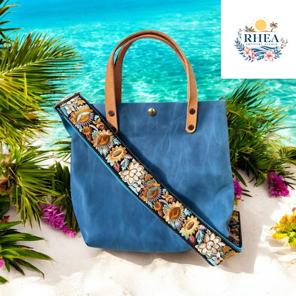 Ethically crafted embroidered replacement purse strap in aqua blue, featuring intricate sunflower motifs on a cream  background on a teal bag
