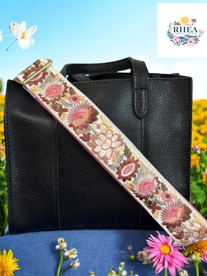 Ethically crafted embroidered replacement purse strap in pink featuring intricate sunflower motifs on a white background at garden