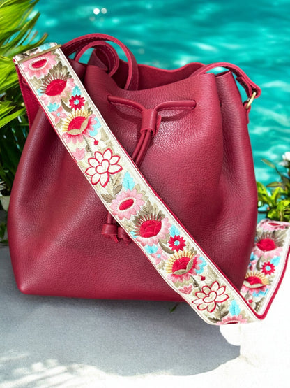 Ethically crafted embroidered replacement purse strap in red featuring intricate sunflower motifs on a cream background.