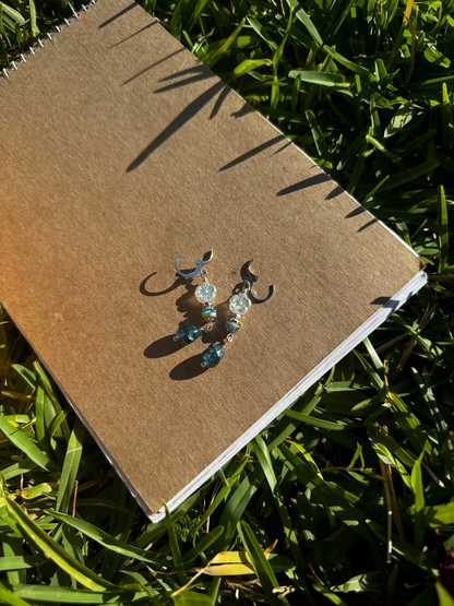 Pair of earrings on a old book