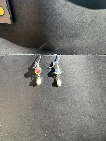 Pair of earrings on a black bag