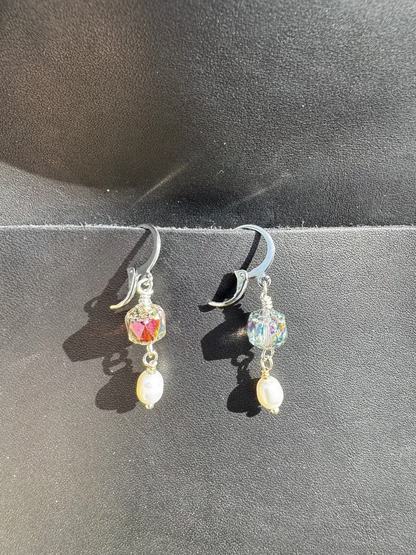 Pair of earrings on a black bag