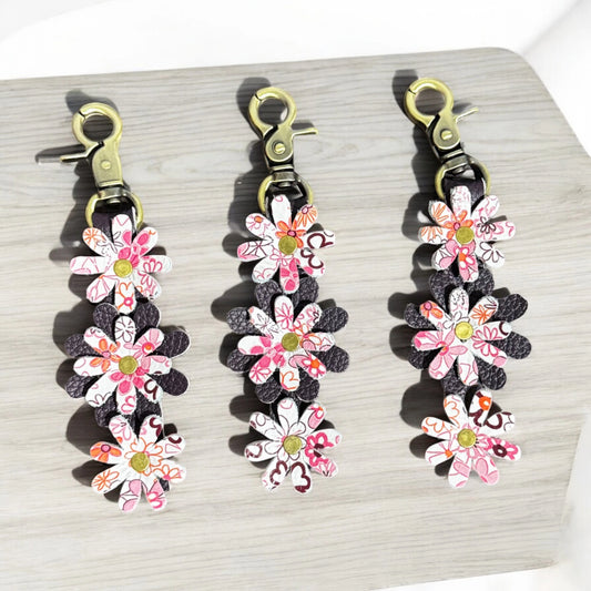 Leather daisy charm keychain with layered floral design and lobster clasp