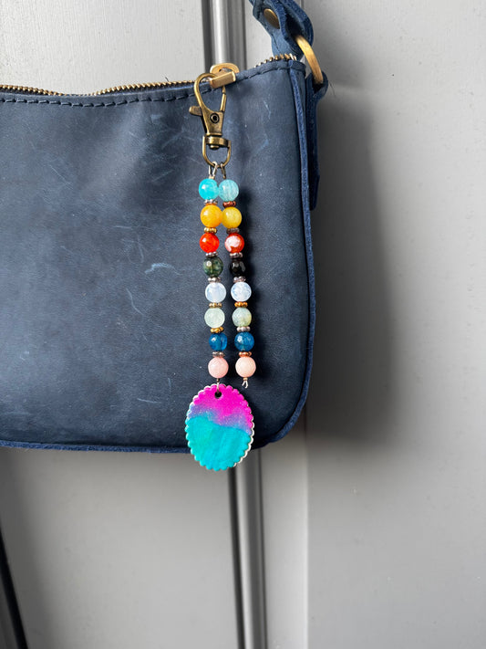 multi colored beaded on 2 strands with a handmade colorful pendant with lobster clasp