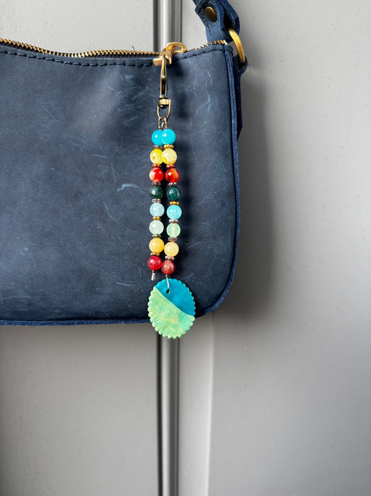 multi colored beaded on 2 strands with a handmade colorful pendant with lobster clasp