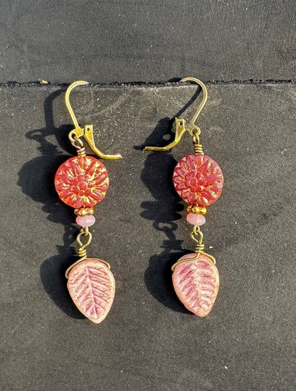 pink dahlia earrings with pink beads on a black bag