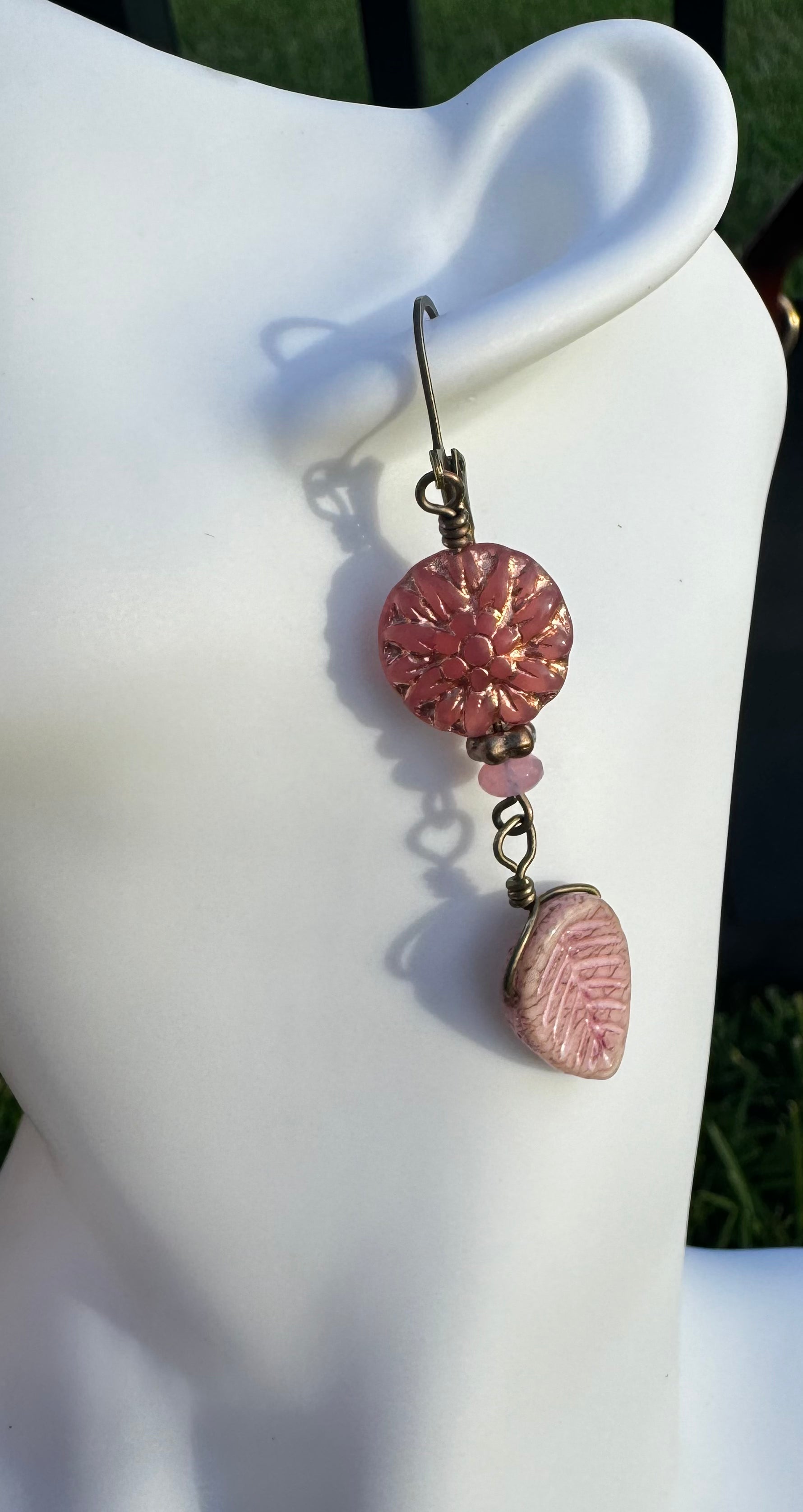 pink dahlia earrings with pink beads on a model