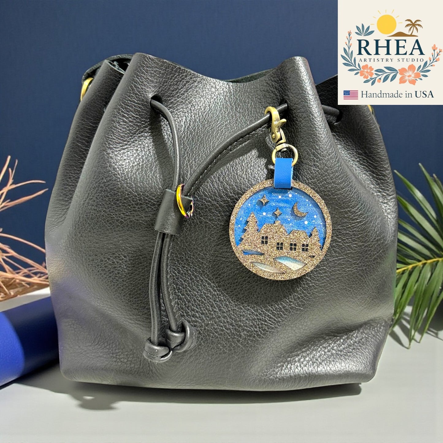 Winter village leather bag charm featuring hand-painted background and veg-tan backing