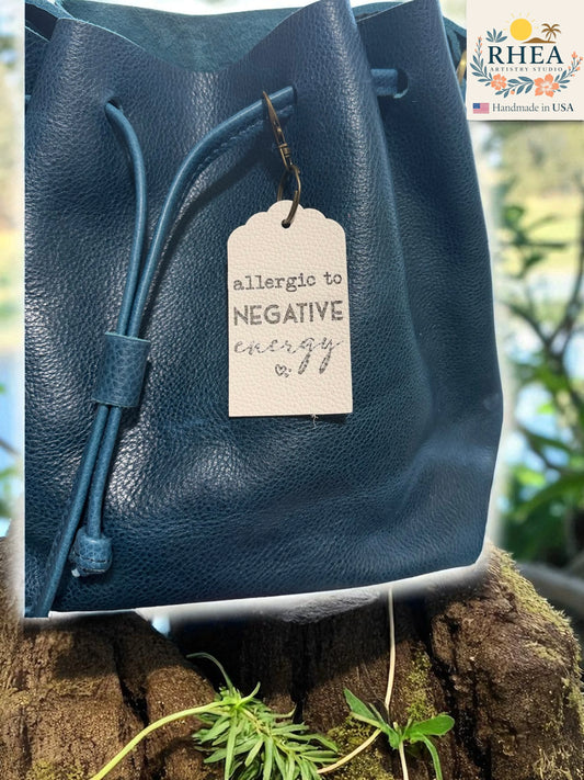 Blue leather bag with a tag on a natural background